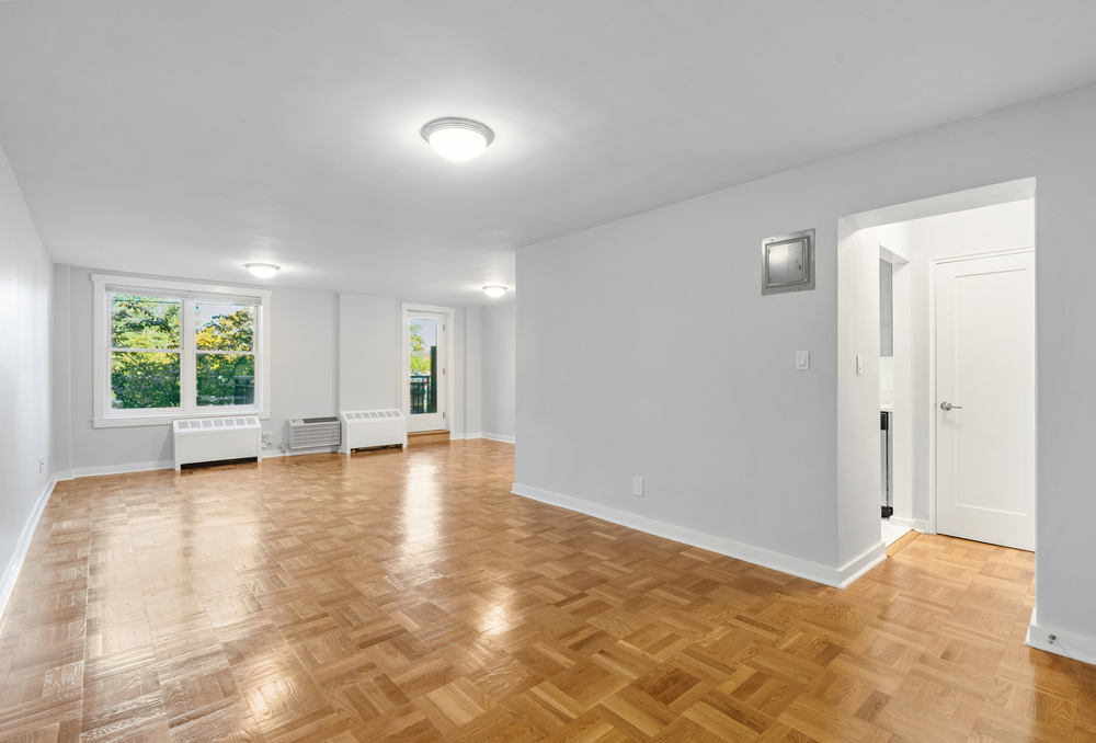 Living room with parquet floors and large window